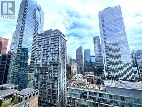 A cityscape with skyscrapers and a building with the text "REALONE REALTOR" on it.