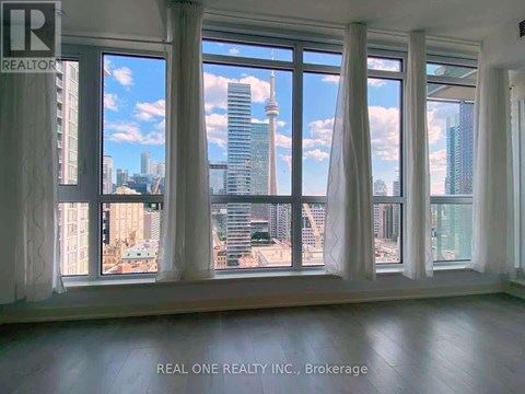 A room with large windows overlooking a cityscape.