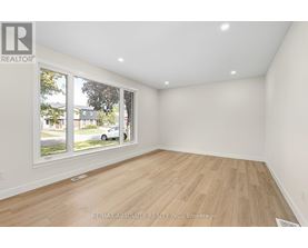 A room with a large window and wooden flooring is on the market with RE/MAX Absolute Realty Inc.