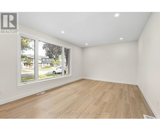 A room with a large window and wooden flooring is on the market with RE/MAX Absolute Realty Inc.