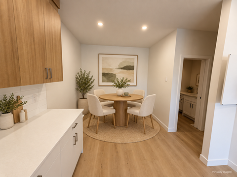 A dining area with a table and chairs.