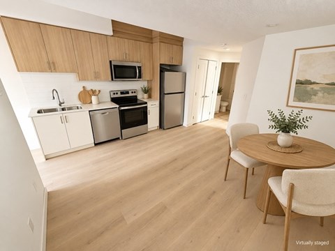 A kitchen with a table and chairs in the middle of the room.
