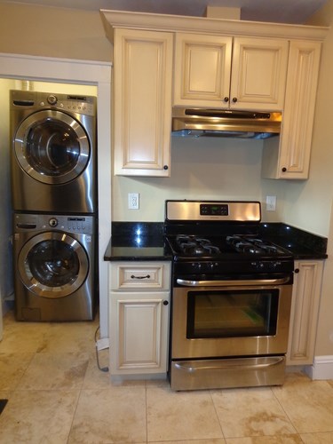 A kitchen with a stainless steel dishwasher and oven.
