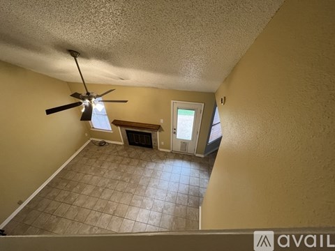 A room with a ceiling fan and a window.