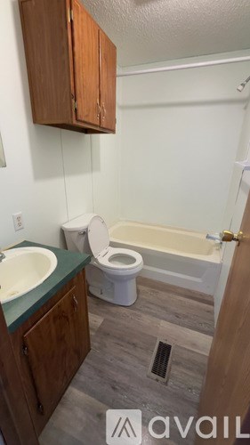 A bathroom with a toilet, sink, and bathtub.