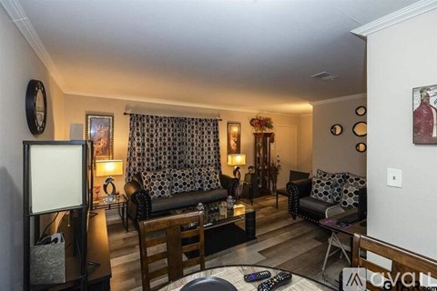 A living room with a black and white patterned sofa and a wooden coffee table.