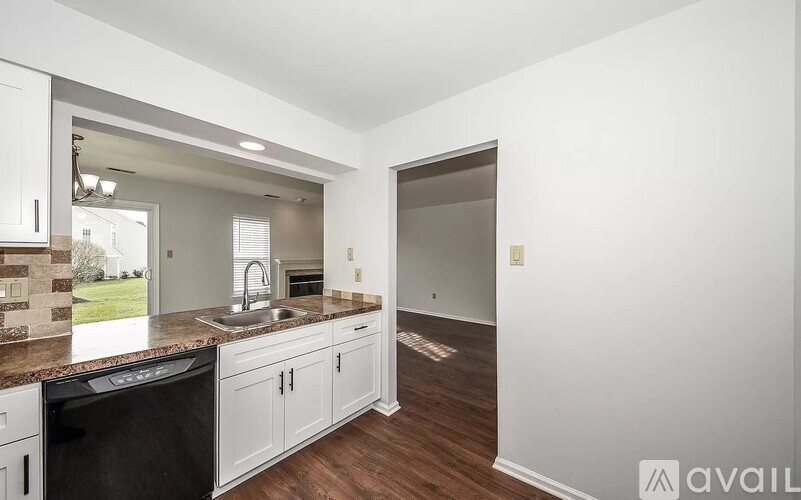 A kitchen with white cabinets and a black oven.