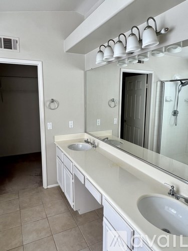 A bathroom with a sink and mirror.