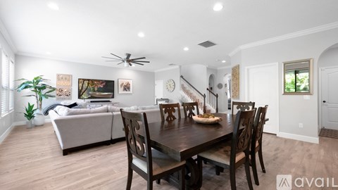 A dining room with a wooden table and chairs.