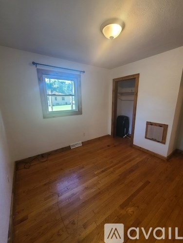 A room with wooden floors and a window.