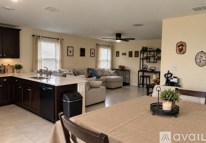 A kitchen with a dining table and chairs in the middle of the room.