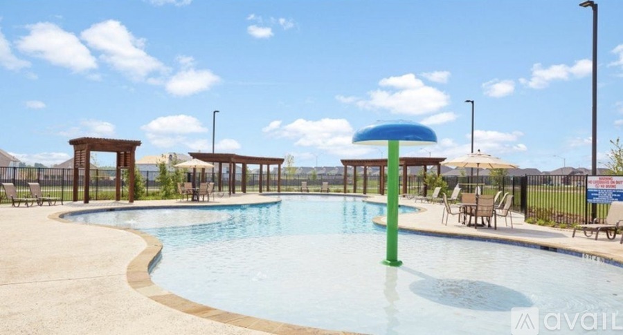 A pool with a blue umbrella and a green pole.