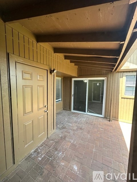 A room with a wooden door and a glass door.