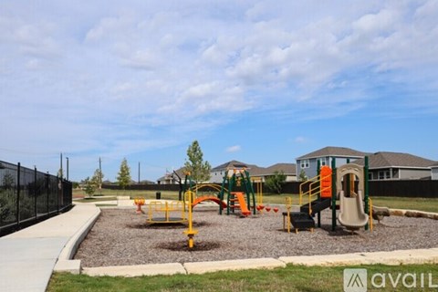 A playground with a slide, swings, and a climbing frame.