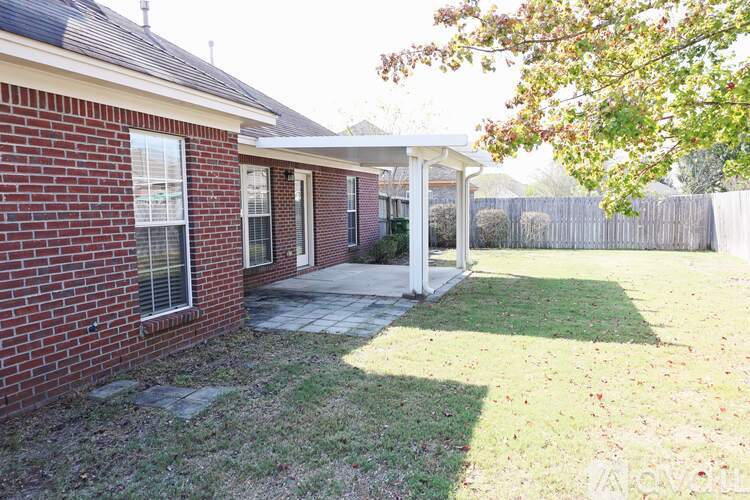 A red brick house with a white porch.