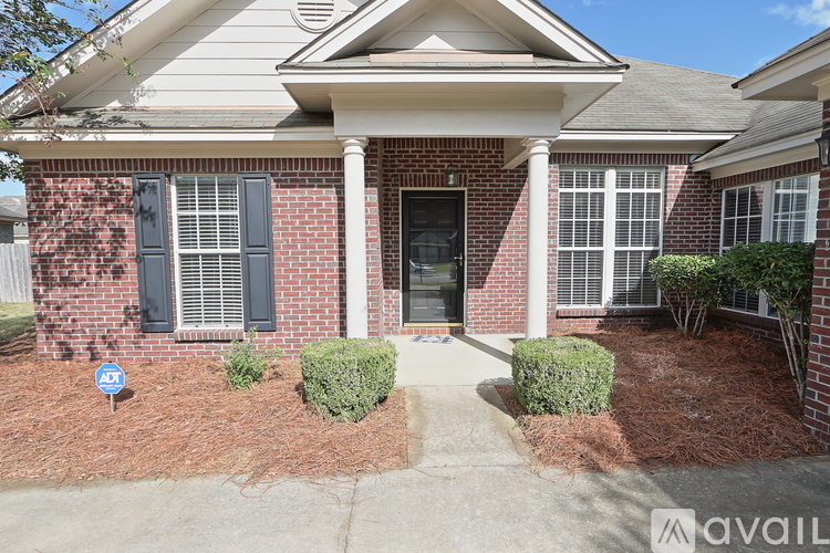 A house with a red brick exterior and a black front door.