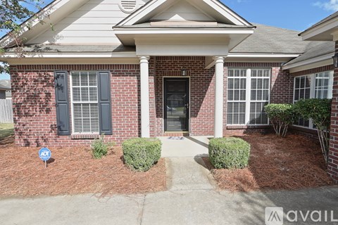 A house with a red brick exterior and a black front door.