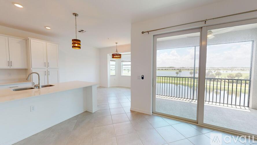 A kitchen with white cabinets and a sink is available for rent.