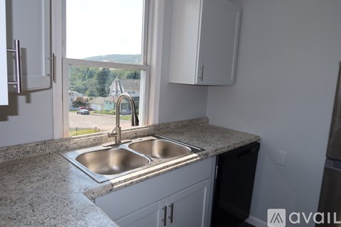 A kitchen with granite countertops and a double sink.