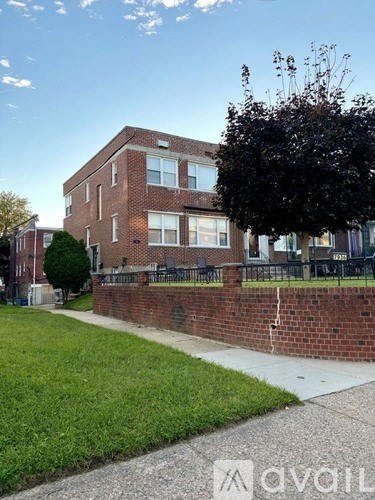 A brick building with a green lawn in front.