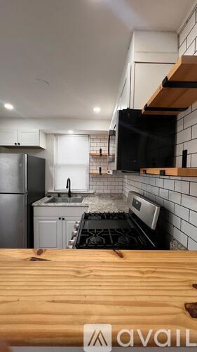 A kitchen with a wooden table in front of it.