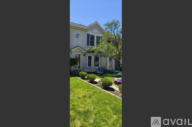 A house with a blue window and a white door is for sale.