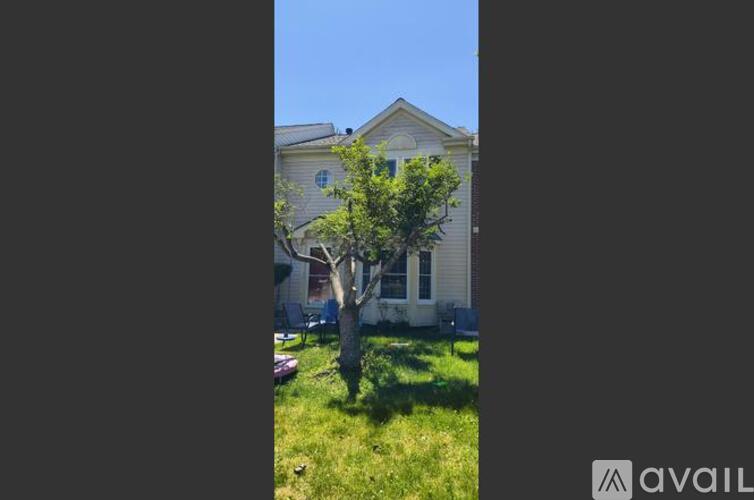 A tree in front of a house.