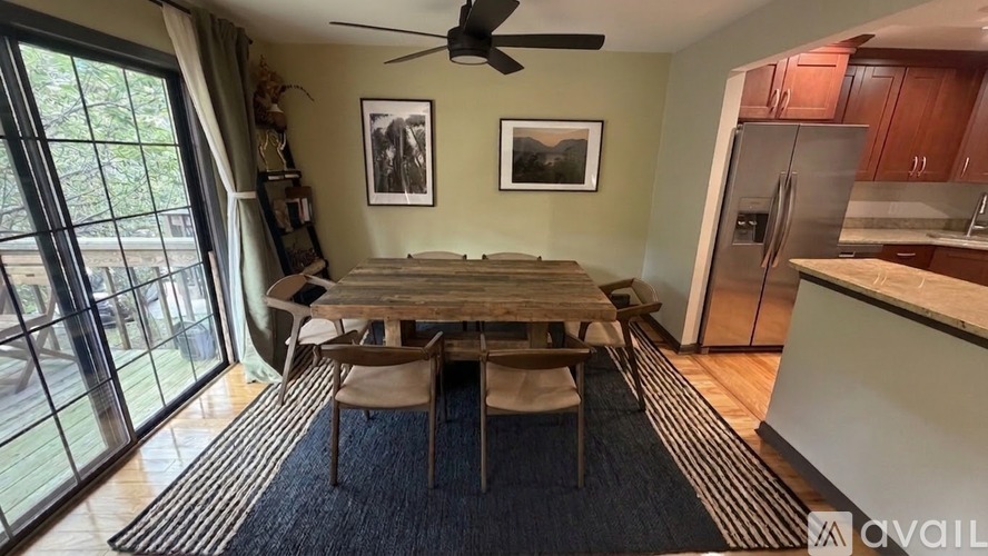 A dining room with a table and chairs is shown.