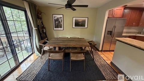 A dining room with a table and chairs is shown.