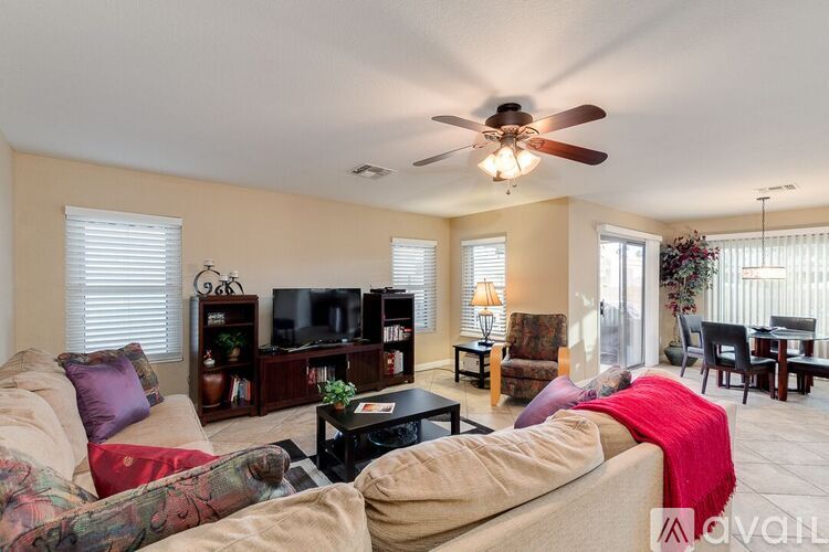 A living room with a couch, a coffee table, and a television.
