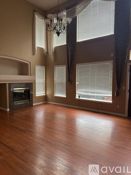 A room with a fireplace and a chandelier.