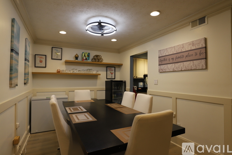 A dining room with a table and chairs.