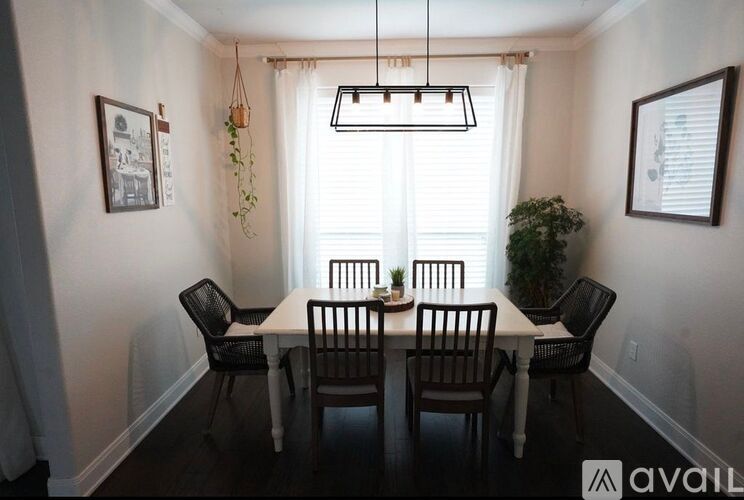 A dining room with a table set for four.