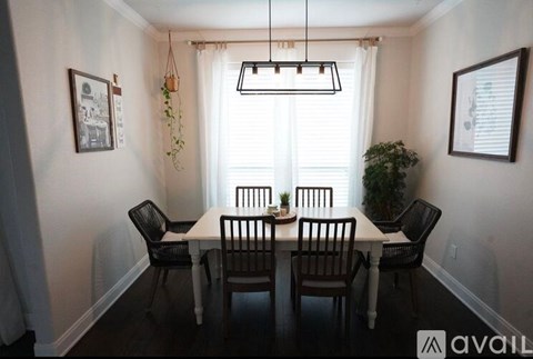 A dining room with a table set for four.