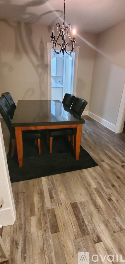 A dining room with a wooden table and chairs.