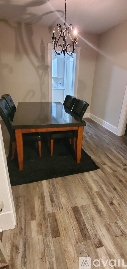 A dining room with a wooden table and chairs.