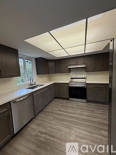 A kitchen with a dishwasher, sink, and oven.