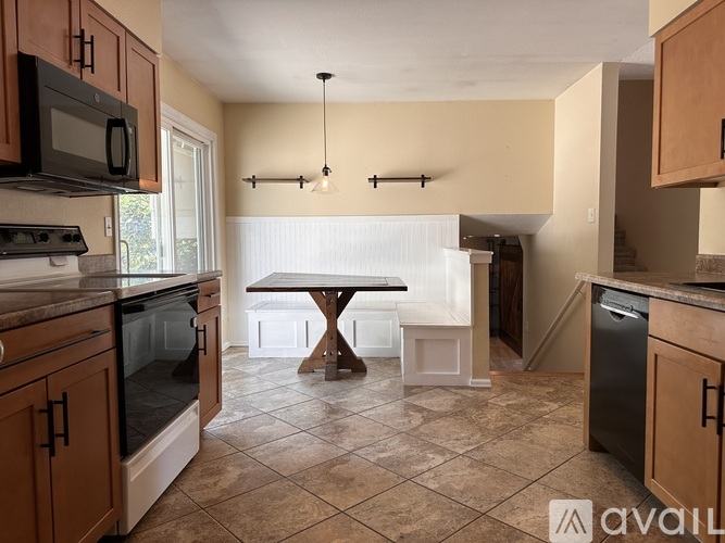 A kitchen with a table and chairs in the middle of the room.