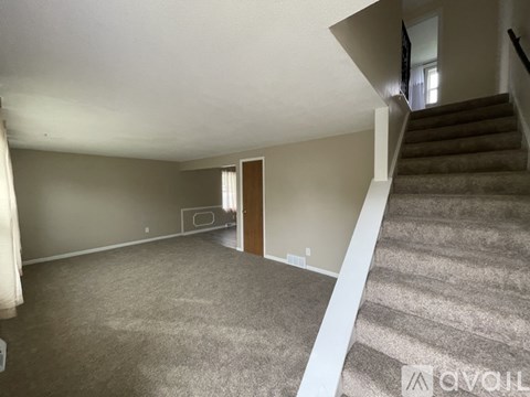 A living room with a staircase leading to the upper floor.