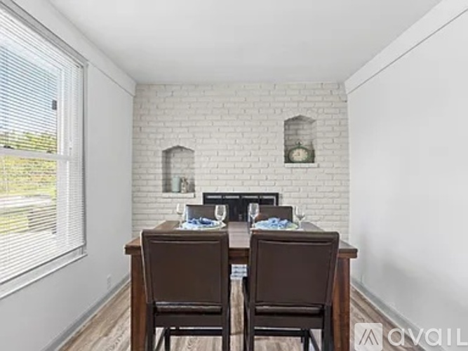 A dining room with a wooden table and chairs.