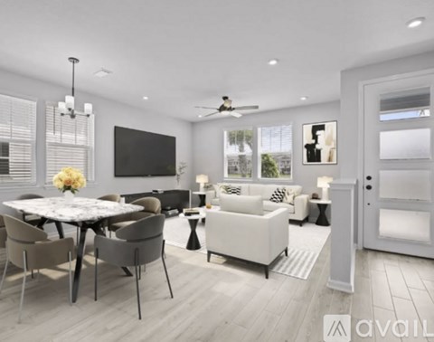 A modern living room with a dining table and chairs.