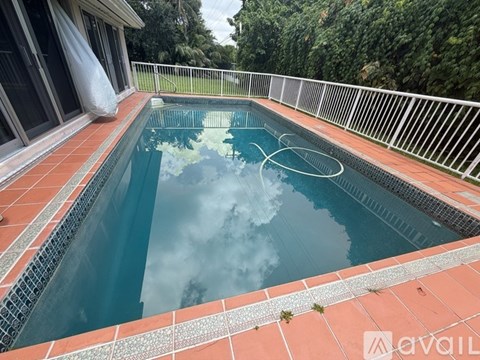 A small pool with a hose in it.