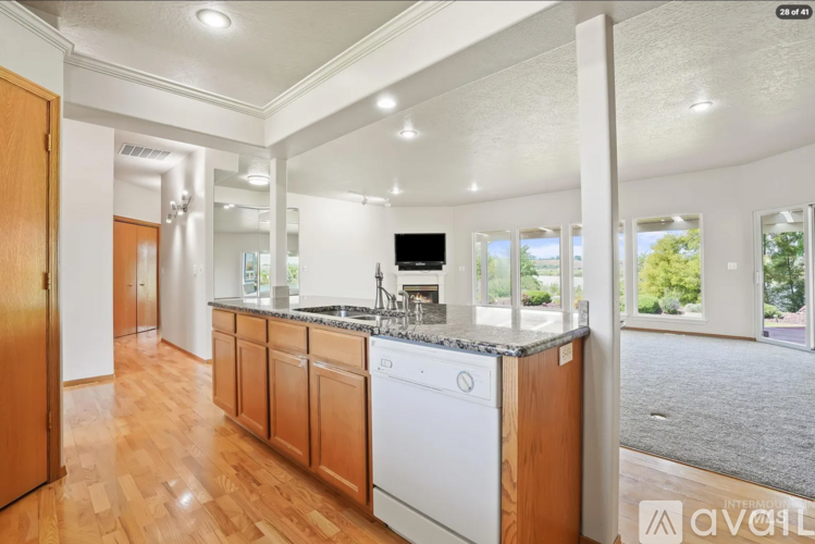 A kitchen with wooden cabinets and a white dishwasher.