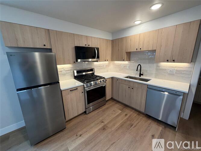 A kitchen with wooden cabinets and stainless steel appliances.