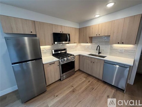 A kitchen with wooden cabinets and stainless steel appliances.