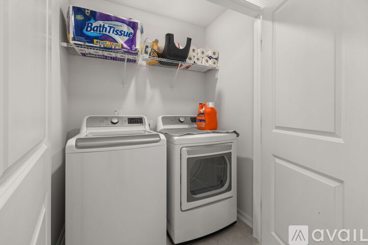 A small laundry room with a washer and dryer.