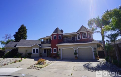 A large house with a red and white exterior and a garage.