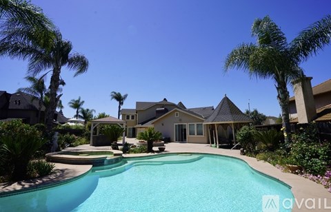 A large house with a pool in the backyard.