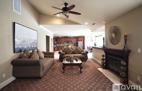 A living room with a fireplace and a painting on the wall.