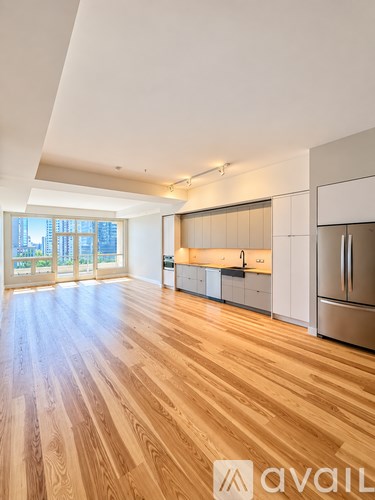 A kitchen with wooden floors and stainless steel appliances.